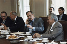 President Bush on the telephone with German Chancellor Helmut Kohl during a meeting with congressmen at the White House, photograph by David Valdez, October 3, 1990