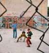 Three boys and 'A Train' graffiti in Brooklyn's Lynch Park in New York City