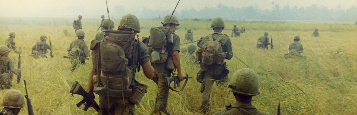 Photograph of Troops Moving across a Rice Field in Search of Viet Cong