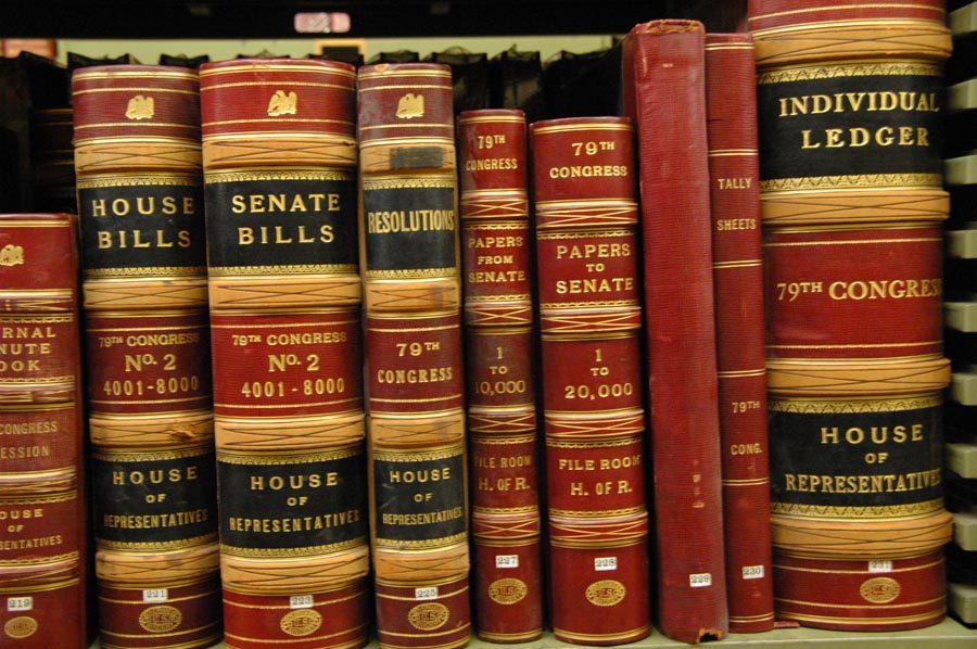 Books on a shelf in the stacks of Legislative Archives