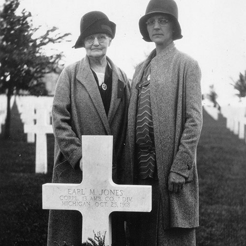 Gold Star mother Mrs B.F. Jones at her son Earl's grave in France