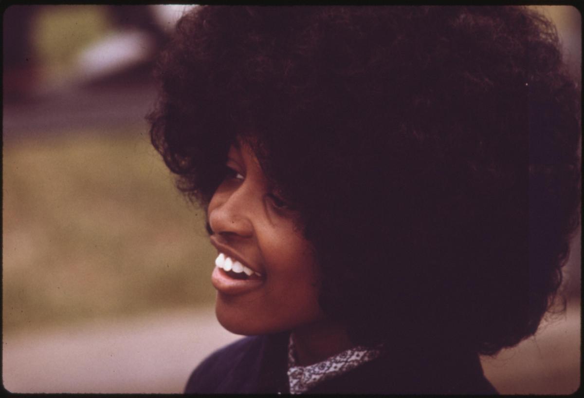 African American woman with an afro smiling
