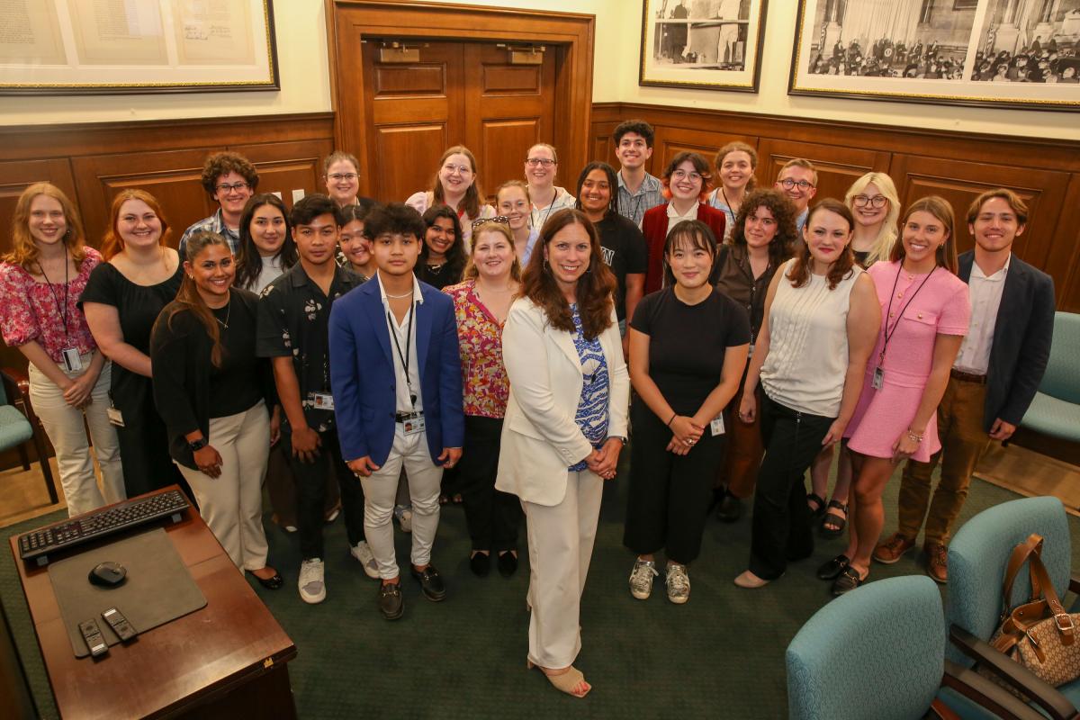 Image of Archivist of the United States Dr. Colleen Shogan at center with Washington DC-area interns