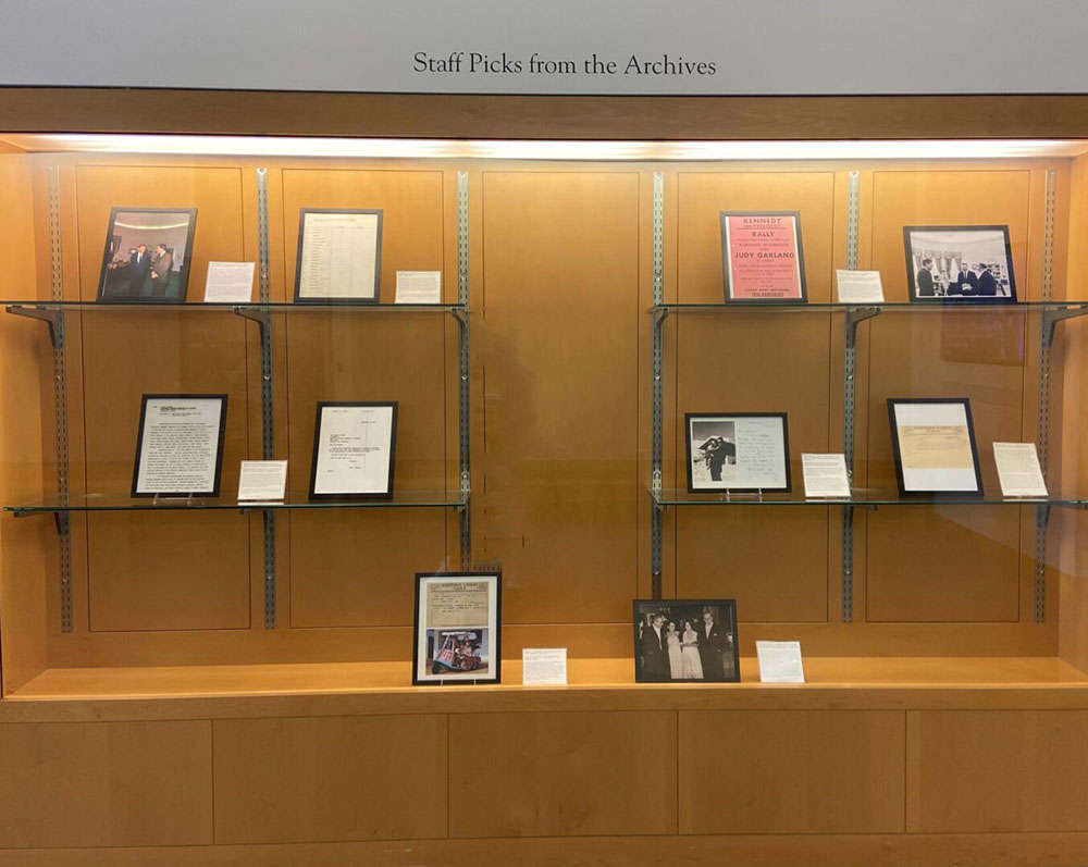 A set of bookshelves displaying JFK Library staff's picks for favorite documents