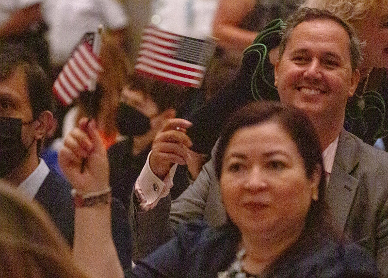 New citizens celebrate swearing in at naturalization ceremony, 9-14-2022, in the National Archives Rotunda