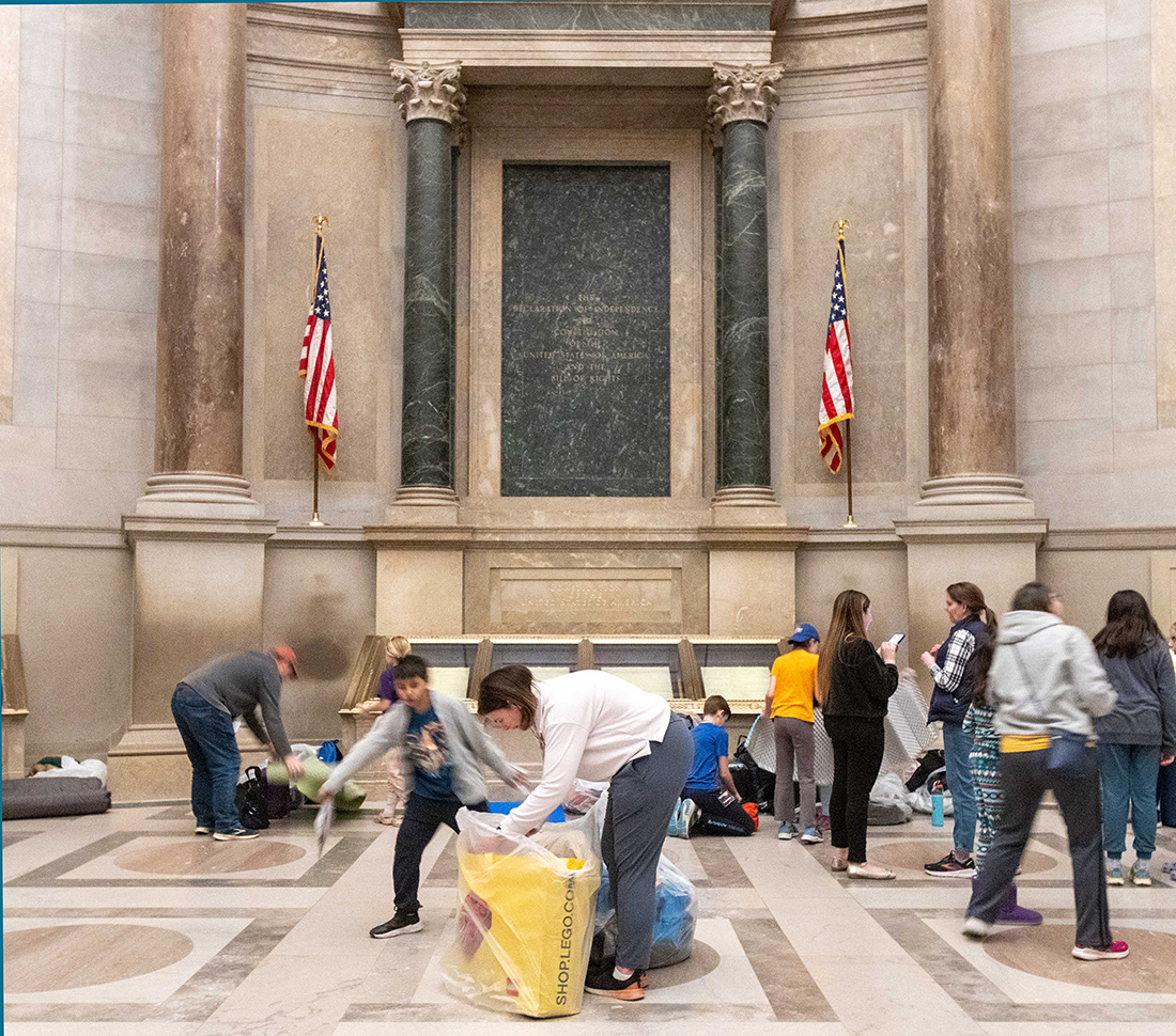 Families set out sleeping bags in the National Archives Rotunda for the Sleeepover