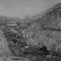 98. Dead Confederate sharpshooter in the Devil's Den, Gettysburg, Pa., July 1863.