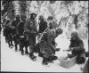 During the Battle of the Bulge, US troops line up for chow