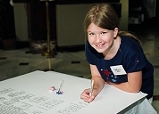 A young visitor 'joins the signers' by adding her name to a facsimile Declaration of Independence at the National Archives' July 4, 2002 celebration at Union Station, Washington, DC